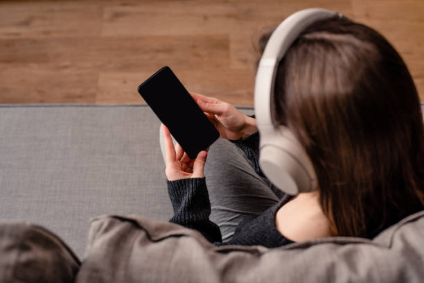 istock Woman listening music on mobile 1268603868