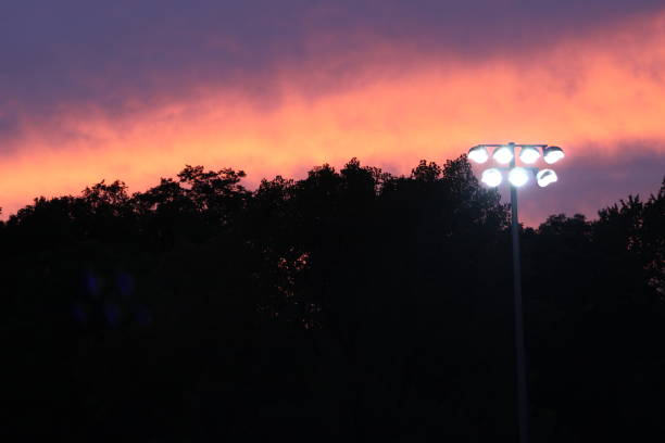 istock Stadium Lights at Sunset - Football Friday Night Lights 1268606907