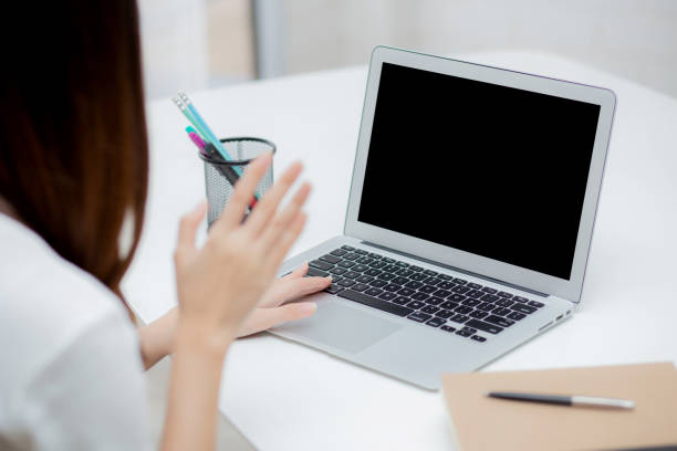istock Young asian business woman using laptop computer blank screen mockup for video call online and communicate work from home, girl conference with notebook, social distancing, communication concept. 1268607015