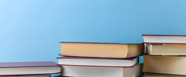 istock Stacks of books several on a blue background close-up. Back to school, education, learning, 1268608808
