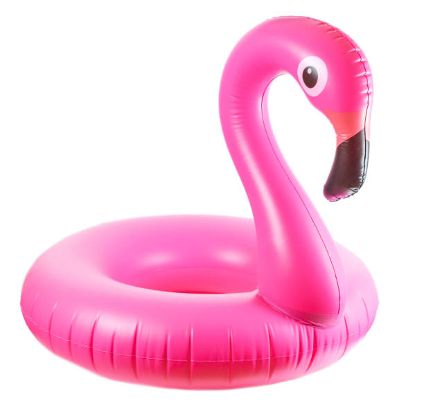 Photo of Flamingo print. Pink pool inflatable flamingo for summer beach isolated on white background. Minimal summer concept.