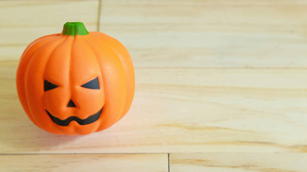 istock jack o lantern toy on  wood table for holiday content. 1268620167