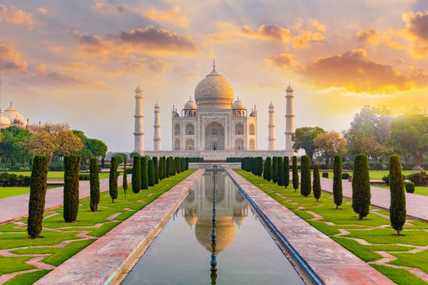 Taj Mahal front view reflected on the reflection pool. Taj Mahal front view reflected on the reflection pool, an ivory-white marble mausoleum on the south bank of the Yamuna river in Agra, Uttar Pradesh, India. One of the seven wonders of the world. india indian culture taj mahal temple stock pictures, royalty-free photos & images