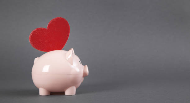 istock Piggy bank with red heart. 1268625517