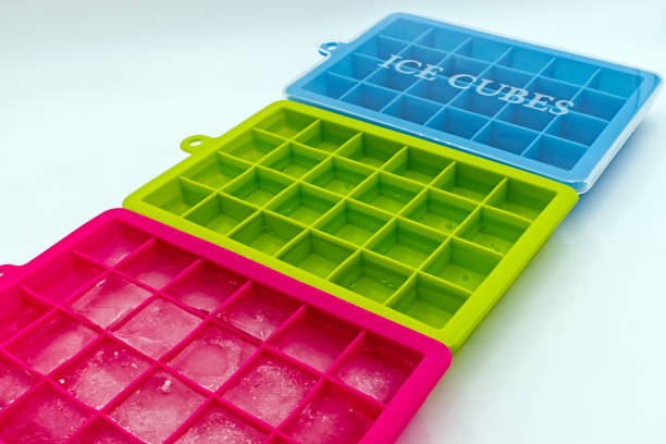 istock Ice cube tray of different colors, isolated on white background 1268628914