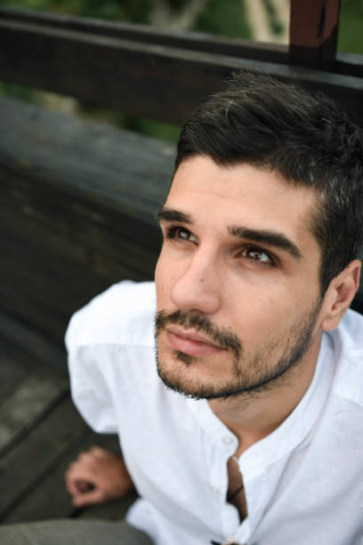 istock beautiful man looks into the distance 1268628989