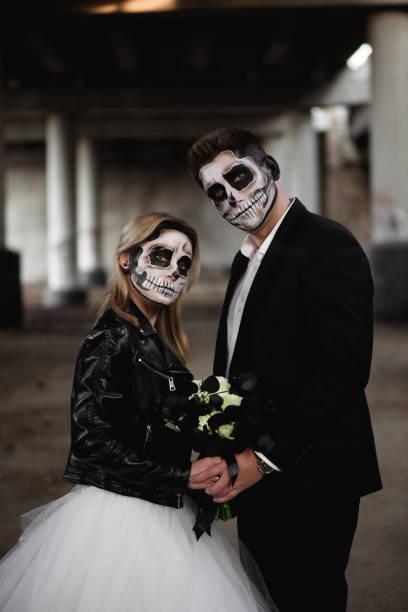 istock Halloween couple. Dressed in wedding clothes romantic zombie 1268631196