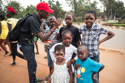 Kampala / Uganda - October 4, 2016: Ugandan children having their faces painted with colors during celebration of Kampala Festival