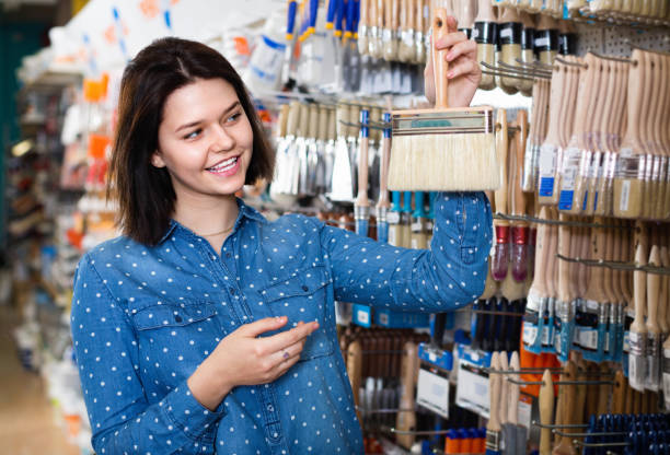 istock Female customer examining various painting brushes 1268634625