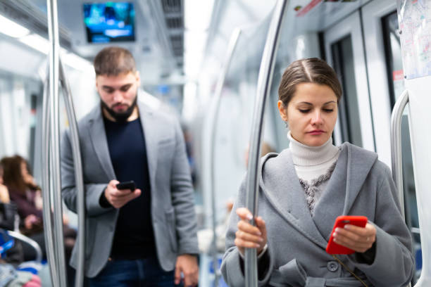 istock Positive woman reading from mobile phone screen in metro 1268635855