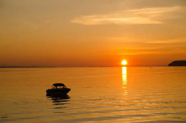 Motorboat parked near fishing pier in Blaine, Washington, during summer  gloaming sunset