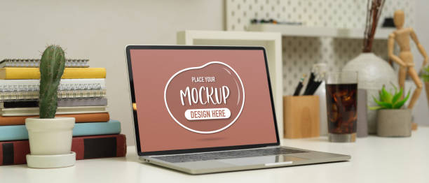 istock Workplace with mock up laptop , books, stationery and decorations on white table 1268638801