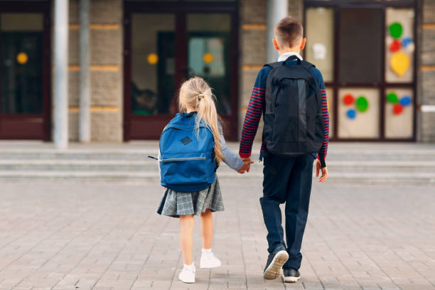 istock Two elementary students brother and little sister going back to school 1268640078