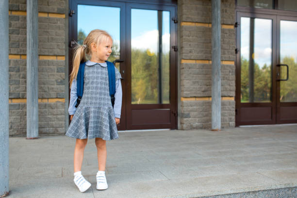 istock Cute little girl with backpack going back to school 1268640137
