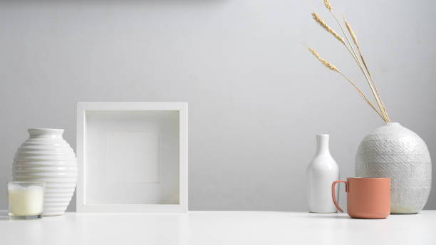 istock Minimal home interior design with copy space, mock up frame, vases and decorations in white concept 1268640146