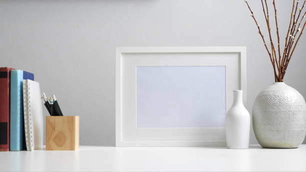 istock Worktable with books, stationery, mock up frame, decorations and copy space 1268640213