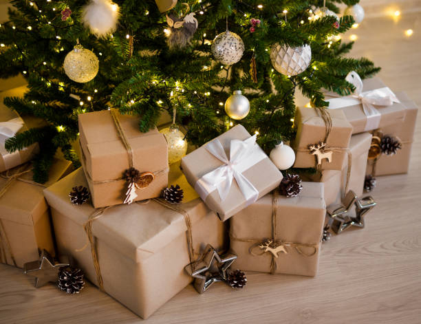 istock close up of beige gift boxes under decorated christmas tree 1268640359