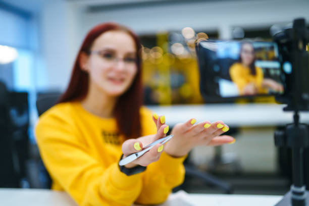 istock Hands of young blogger is recording video and talking with gesturing 1268641837