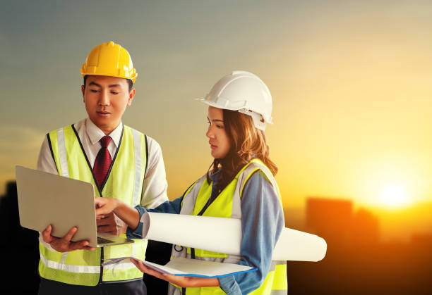 istock two contractor engineer Civil developer male and female is discussing on document plant with Sunset is the background. 1268648716