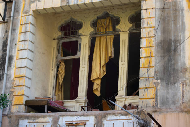 Crisp white sheets hanging out of beautiful old building.