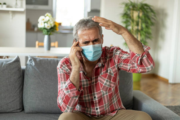 istock Depressed Mature Man With Protective Mask Talking to a Psychiatrist 1268650908