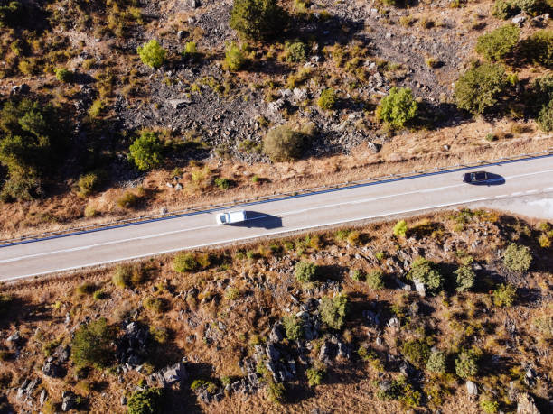 istock Aerial shot with drone looking down at road 1268651545
