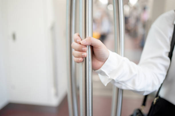 istock Close-up of a woman's hand holding a pole on the subway. 1268651601