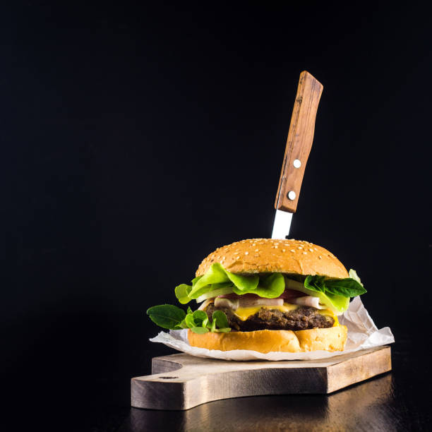 istock Hamburger with beef and ham on a black background 1268652367