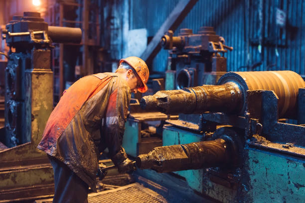 istock Heavy Industry Worker Working Hard on Machine. Rough Industrial Environment 1268653532