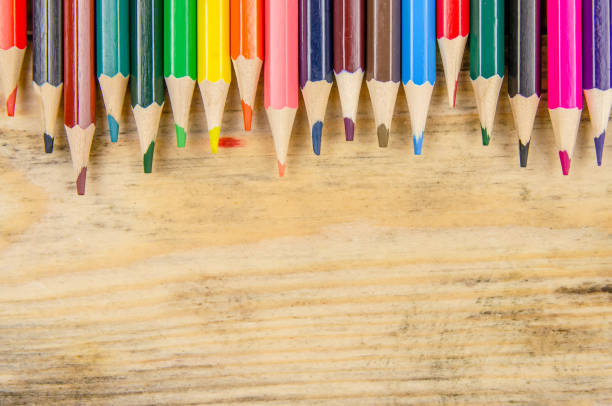 istock Background with colored pencils and space for copying space on a wooden background, top view. Artistic background 1268654481