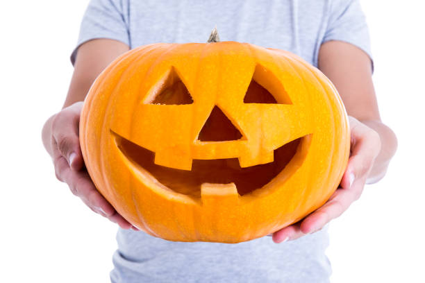 istock Halloween concept - pumpkin Jack-O-Lantern in male hands 1268654642