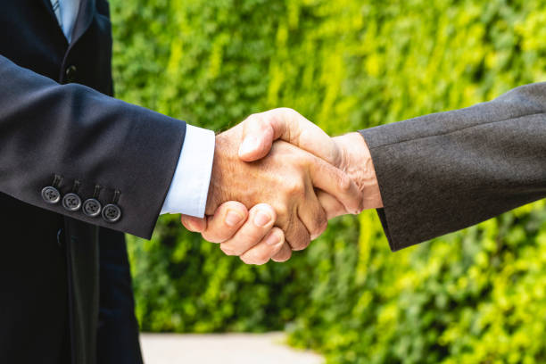 istock Corporate Professionals Shaking Hands in Agreement 1268655416