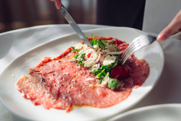 Red beef carpaccio in a white plate