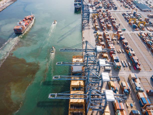 istock Drone aerial shot point of view Logistics business for e-commerce and import,export Container Cargo ship in asia business and technology concept at shipyard at sunset , logistic import export and transport industry background useful for design 1268655450