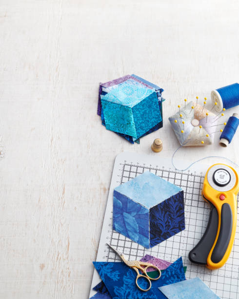 istock Preparation for sewing a cube from rhombuses, pile of stitched cubes, quilting accessories. Space for text. 1268657409