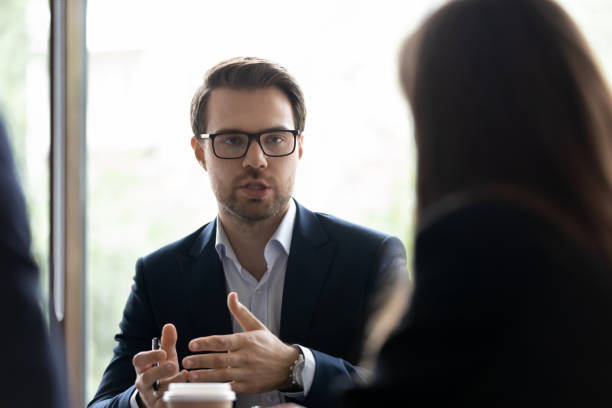 istock Concentrated manager explaining his point of view to colleagues 1268659465