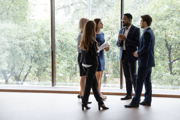 istock Diverse teammates sharing ideas in office hall 1268659522
