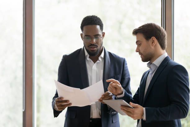 istock Caucasian manager explaining african client deal details 1268659526