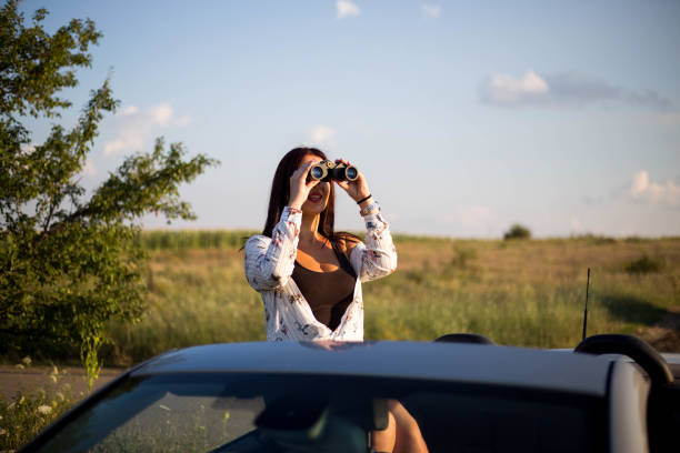 istock A woman with binoculars observes nature 1268661218