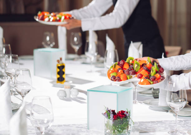 istock Waiters serving table in the restaurant preparing to receive guests. 1268661253