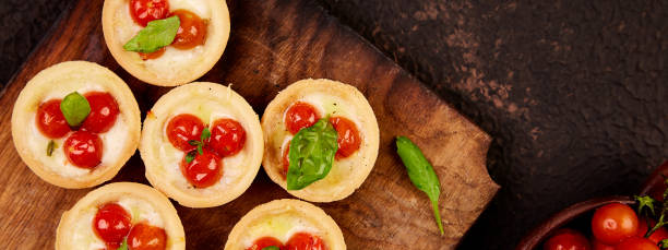 istock Banner of Mini tarts with cherry tomatoes 1268661522