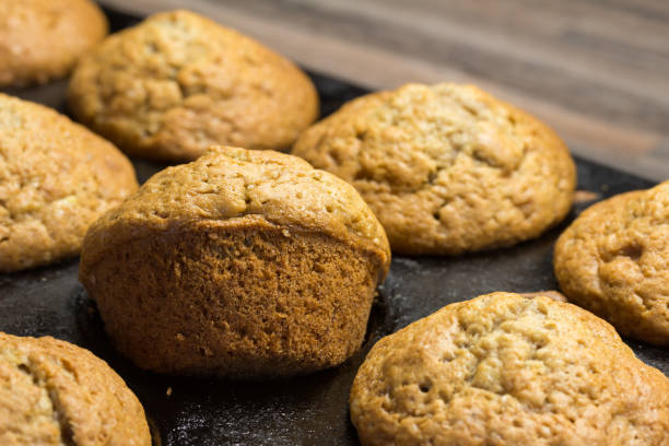 istock Baked muffins in a baking tin on kitchen counter - selective focus 1268661759