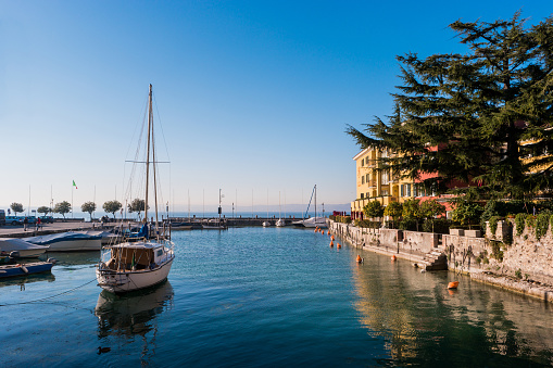 Small tourist port with private boats on Garda Lake, Sirmione, Brescia, Italy.