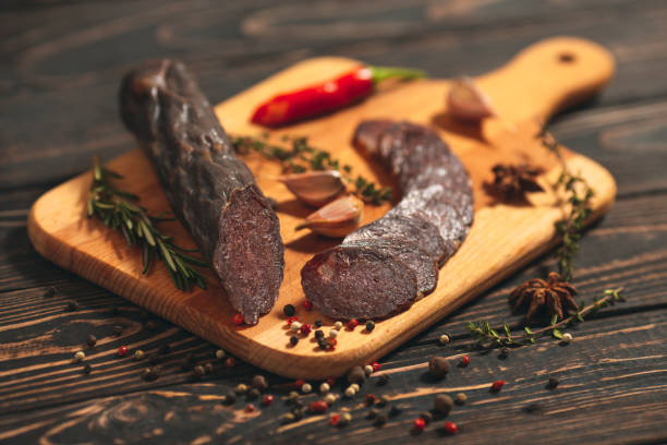 istock sausages on a wooden Board on the table 1268663098