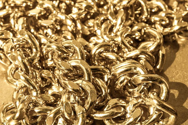 istock Gold chain on a gold background. 1268669885