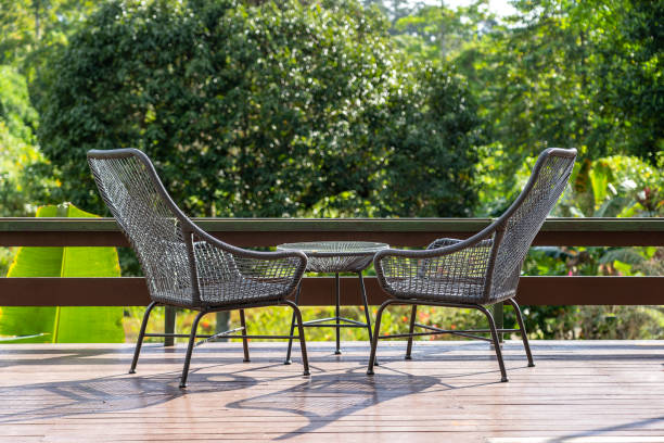 istock Two chairs and table on the backyard in tropical garden with beautiful view 1268674391
