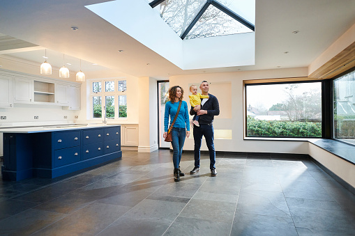 young family looking round new house