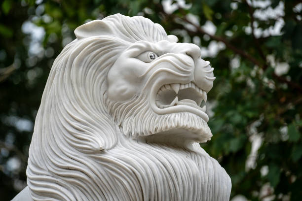 istock Marble white lion statue in outdoors park, Vietnam. Closeup 1268675084