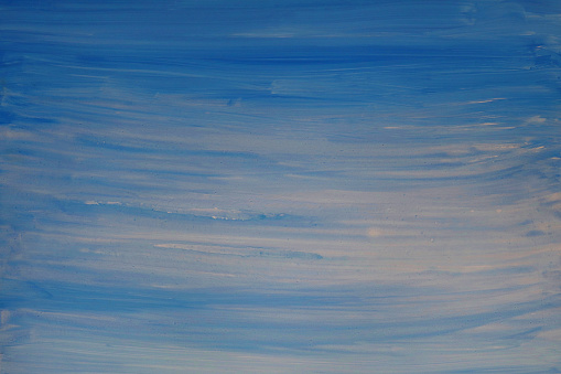 Stock photo showing a close-up elevated view of textured blue sky background, cloudy striped pattern with copy space.