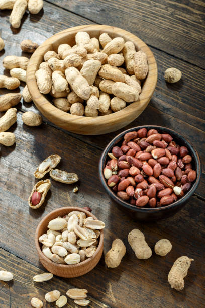 istock Peeled and unpeeled peanuts in a bowl 1268681107